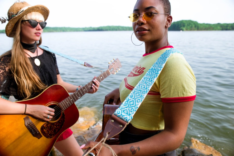 Two girls with handwoven Original Fuzz guitar strap standing by the lake in Nashville.