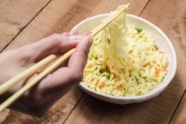Ramen noodles nutrition: Person picks up ramen with chopsticks