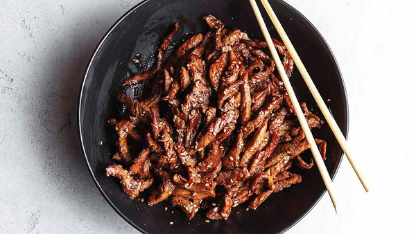 meaty korean beef bulgogi served in black plate with chopstick