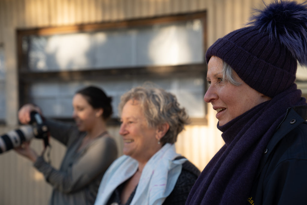 Image of three woman smiling next to each other