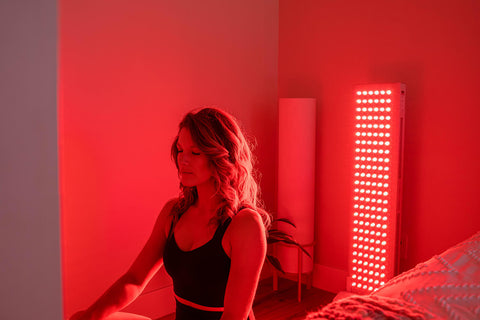 female meditating during red light therapy