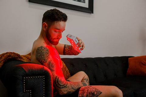 man using mobile red light therapy device