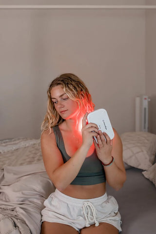 woman using portable mito red light therapy