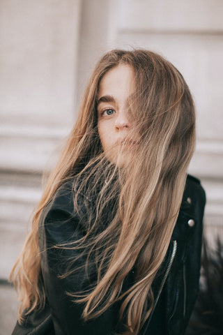 A woman with long hair looking towards the camera 