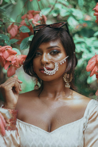Woman with full makeup with a traditional nose ring 
