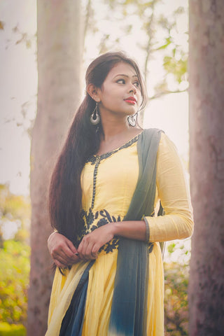 Indian woman in a yellow churidhar with long hair 