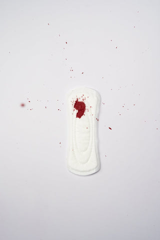 A white pad with spots of blood on it 