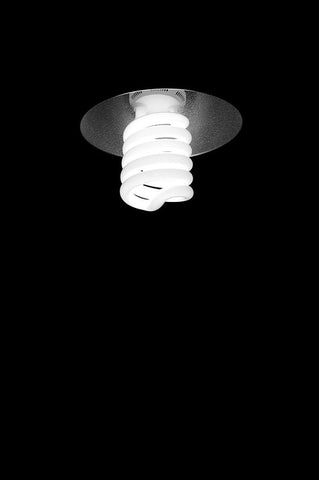 White CFL bulb lit in a dark room 