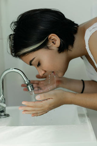 Woman washing her face 