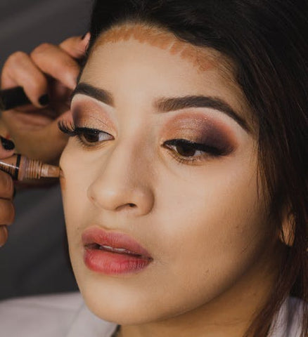 Girl applying makeup on her face