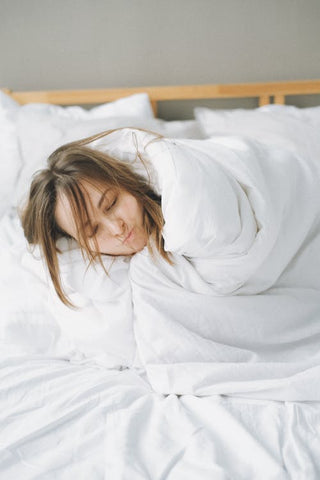 Woman sleeping in her bed with messy hair 