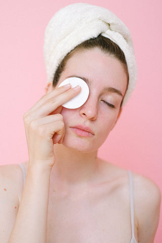 Woman using a makeup wipe on her eye