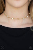 Paparazzi Stunningly Stunning - Gold Glassy white rhinestones dot a dainty gold chain around the neck for a stunning look. Features an adjustable clasp closure.

