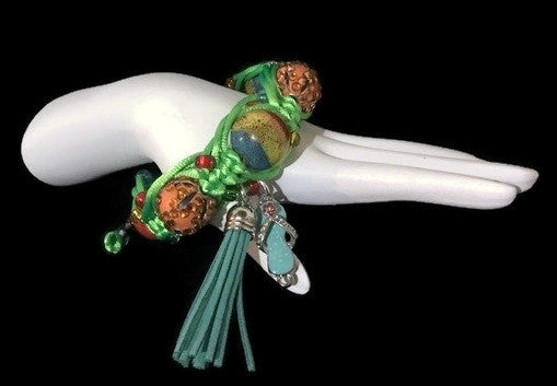 https://www.andreawagnerdesigns.com/collections/bracelets/products/boho-chic-adjustable-beaded-bracelet-handmade-macrame-bracelet-green-nylon-cord-orange-beads-variegated-ceramic-beads-the-summer-green-parrot-bracelet