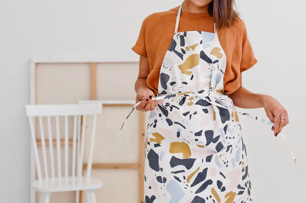 hand sewn apron in abstract pattern shown on woman