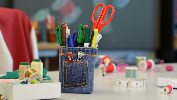 Pen Holder made from denim scraps on a craft table