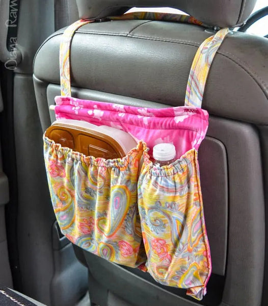 handmade Seatback Refreshment Station shown hanging on back of car seat