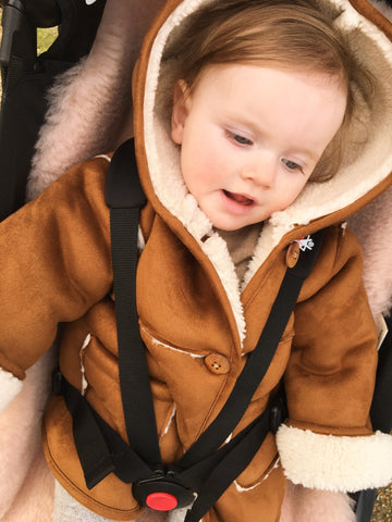 baby sat on binibamba sheepskin pram liner in her baby zen buggy