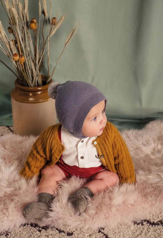 sheepskin large rug with baby sat on it all comfy and cosy from BINIBAMBA