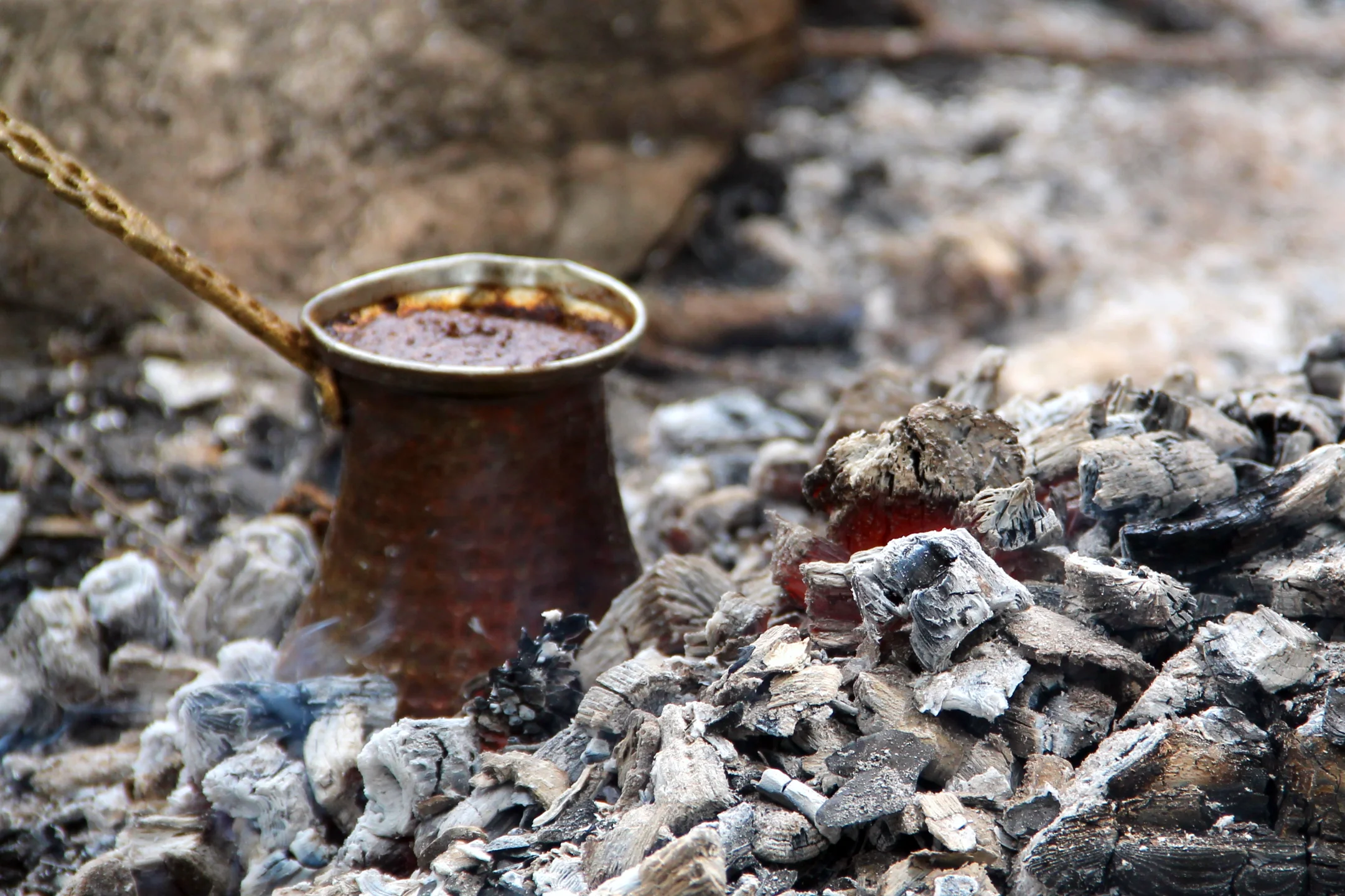 Coffee preparation in the cezve in glowing coals.