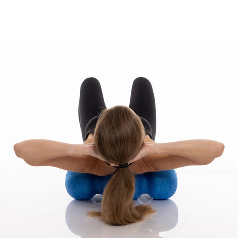 woman foam rolling her back on a rollga foam roller