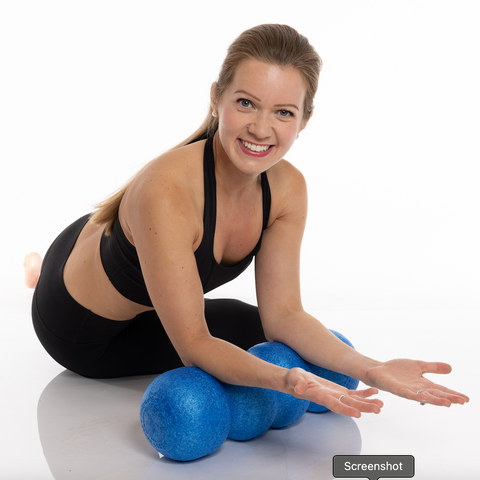 woman foam rolling her arms on the rollga foam roller. white background