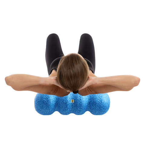 The better foam roller positioned under the back to massage and roll out the muscles along the spine to reduce back pain and tightness