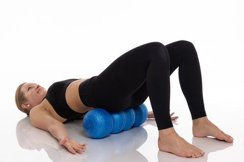 woman laying on a rollga foam roller