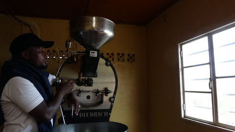 Mr coffee  from Huye mountains showing his roasting machine