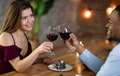 woman and man enjoying a glass of red wine