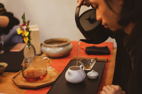 Brewing tea and practicing Chinese calligraphy