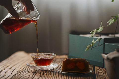 Pouring Puerh Tea paired with mooncakes for Mid-Autumn Festival