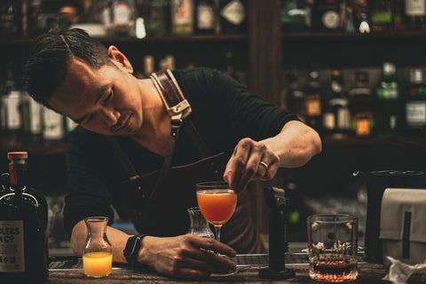 Mixologist puts the finishing touches on a cocktail