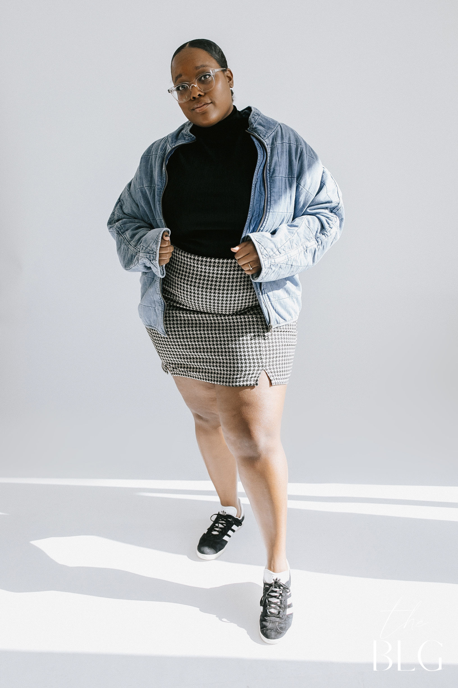 Model wearing a skirt and sneakers