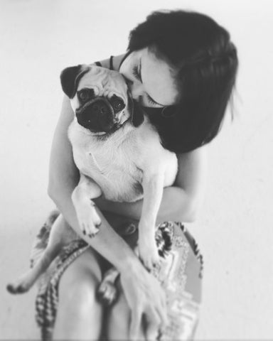 Image of Shabana Jacobson and her dog in the studio.