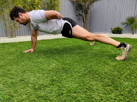 man doing a one armed push-up