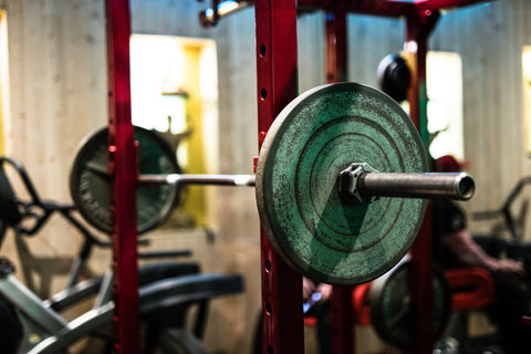 squat rack in gym with barbell