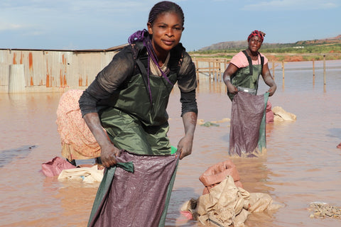 two women washing ore at an artisanal mine site