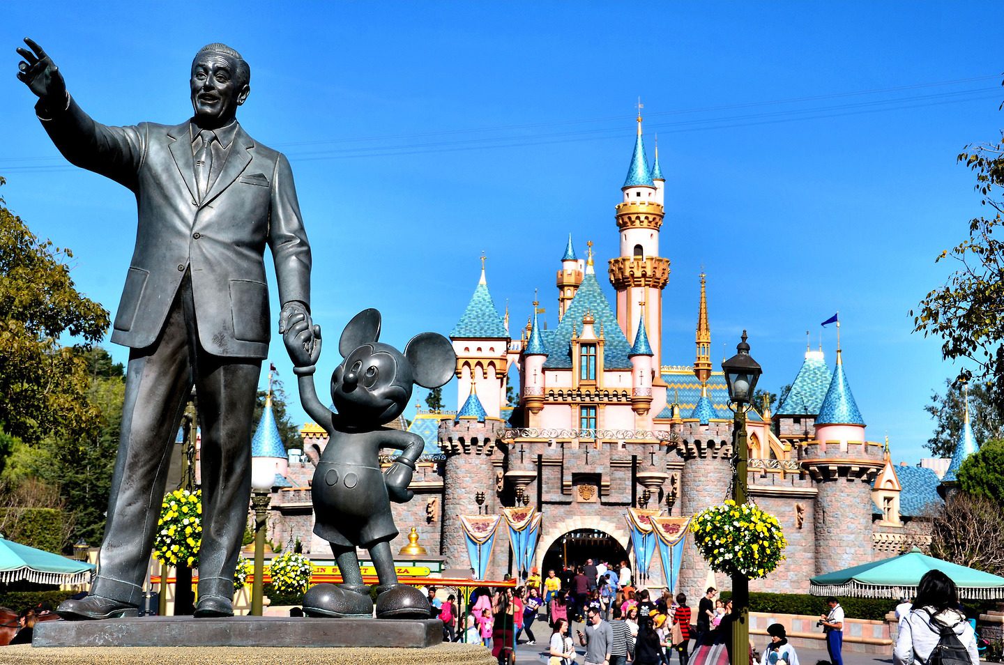 Уолт дисней создал. Уолт Дисней Диснейленд. Диснейленд (Walt Disney World), Флорида. Статуя Уолта Диснея. Памятник Уолту Диснею и Микки Маусу.