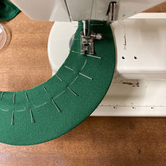 Panel cap peak being sewn on sewing machine