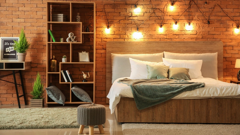 A bedroom with some decorative lights hanging from the wall.