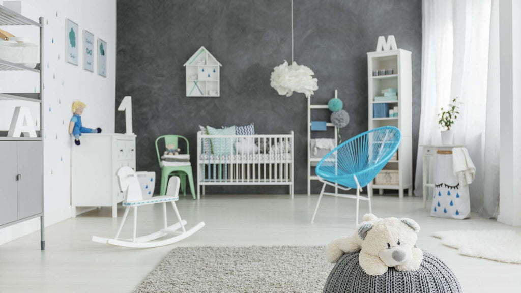 A gray accent wall in a nursery