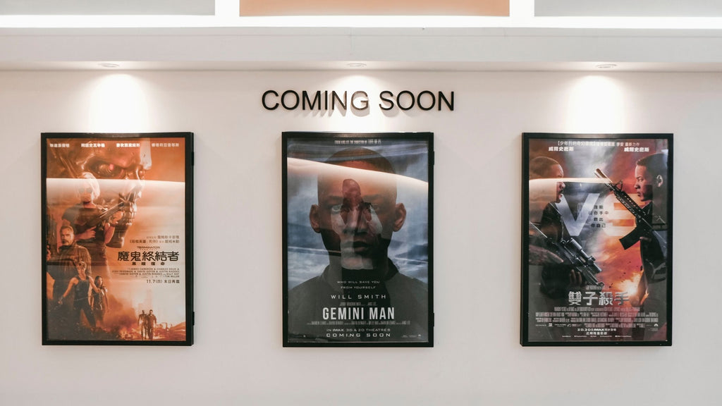 Three movie posters hanging on a wall. 