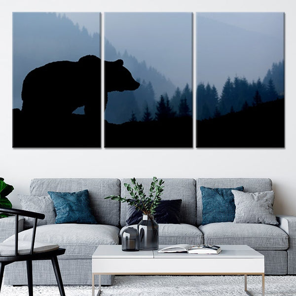 A canvas print of a bears silhouette overlooking a forest. 