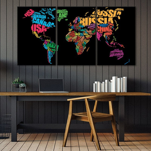 A canvas print of the world with each countries name written out in the shape of the country. It is hanging on an office wall. 