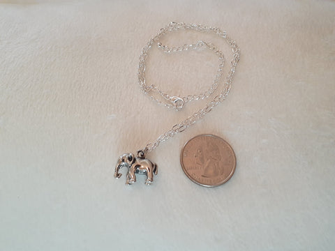 elefootprints-elephant-necklace-silver-comparing-size-to-a-quarter_2