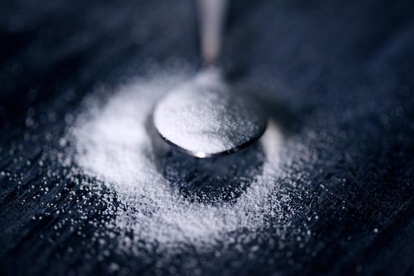 powdered sugar placed on spoon close up view