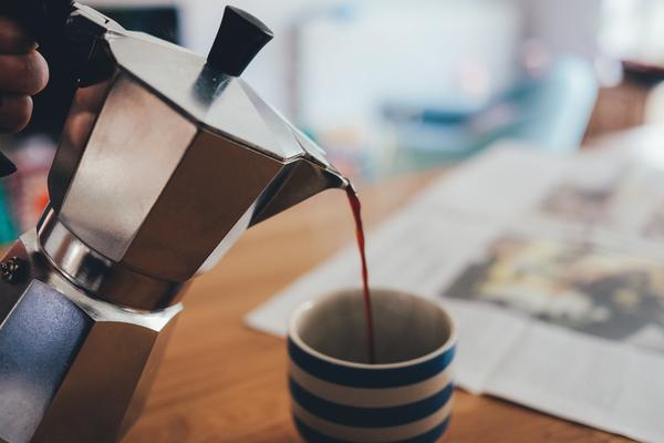 coffee being poured from a pot to a mug