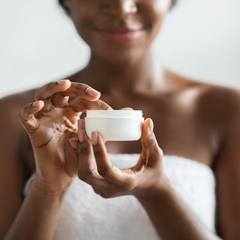 Black Woman Holding Lotion Jar