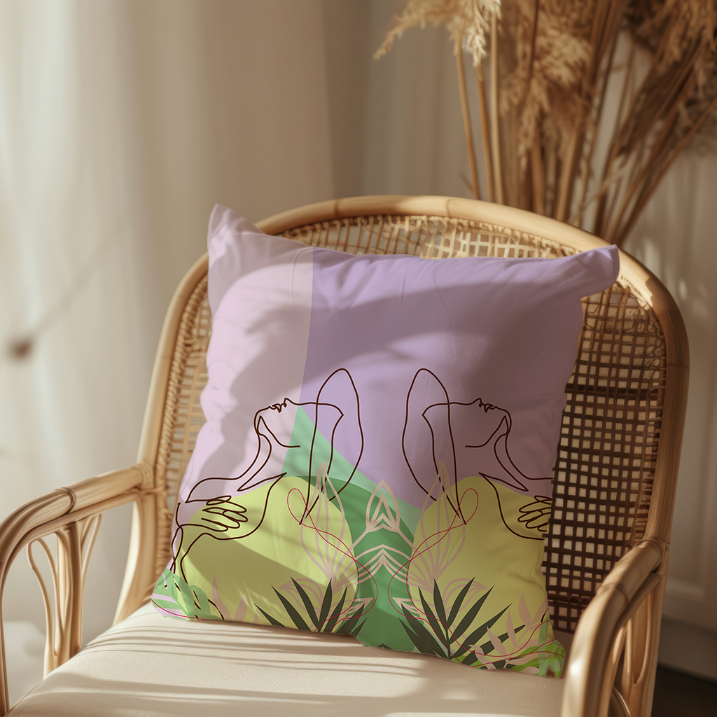 a lilac and soft yellow coloured cushion with a abstract female form and botanical leaf design on a rattan chair